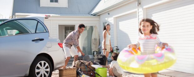 a happy family loading their new car for a fun day at the beach